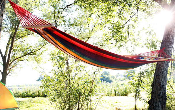 Empty hammock outdoors on sunny day. Summer camp - Fotó, kép