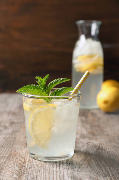 Natural lemonade with mint in glass on wooden table - Foto, imagen