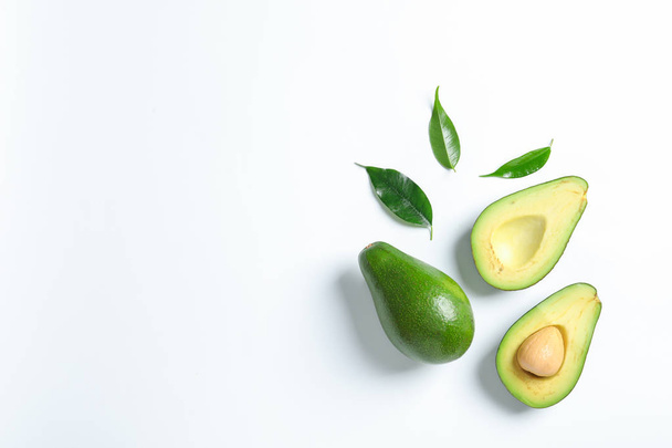 Composition with ripe fresh avocados on white background - 写真・画像