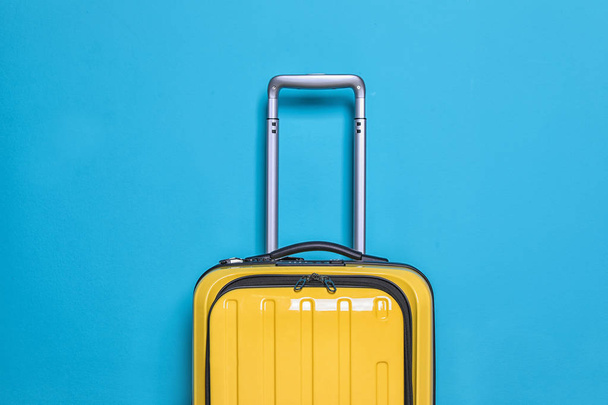 Packed bright yellow suitcase on color background - Foto, Imagen