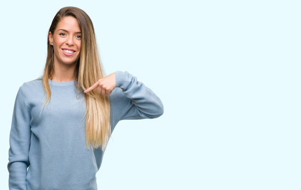 Beautiful young woman wearing sweater and jeans with surprise face pointing finger to himself - Photo, Image