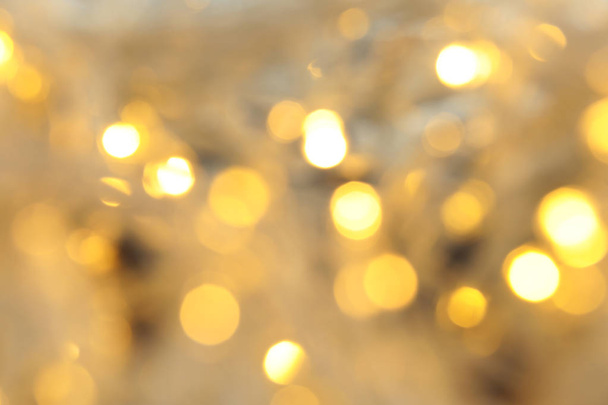 Blurred view of glowing Christmas lights, closeup - Zdjęcie, obraz