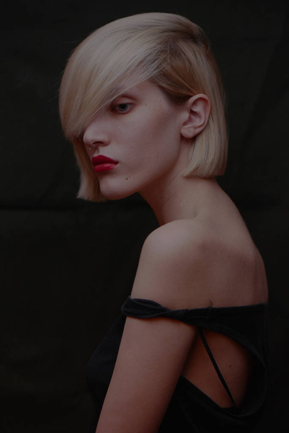 portrait of beautiful blonde woman with piercing in nose and red lips  - Fotó, kép