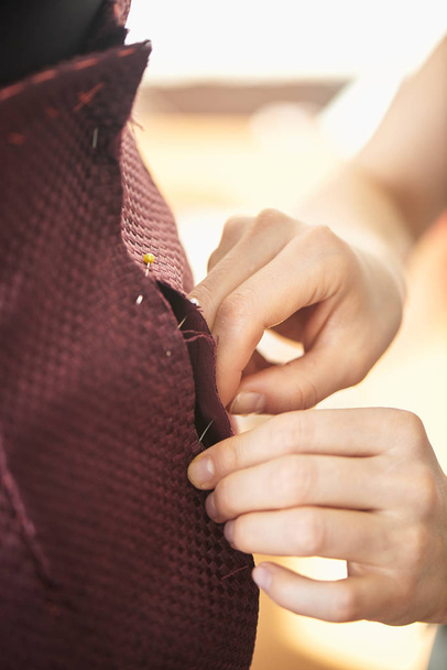 female professional seamstress measuring skirt on mannequin in atelier - Φωτογραφία, εικόνα