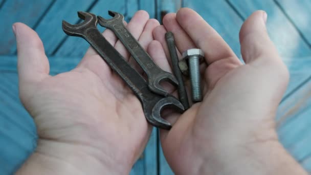Hands of a man dump various tools on a blue wooden background - Footage, Video