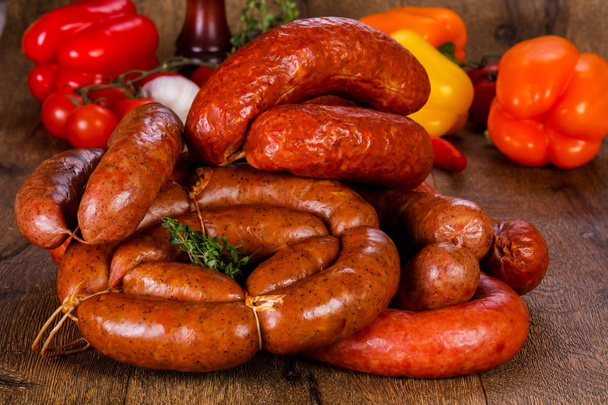 Pork sausages over wooden background - Photo, Image