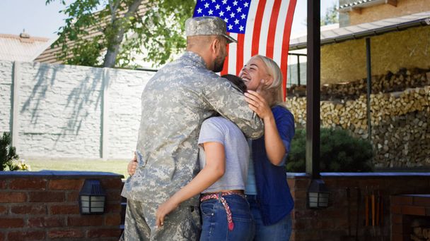 Excited family meeting serviceman at home - Photo, Image
