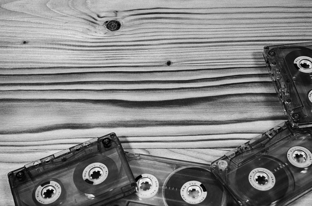Audio cassette on a wooden table in black and white. - Photo, Image