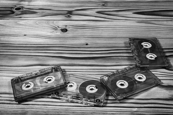 Audio cassette on a wooden table in black and white. - Photo, Image