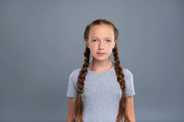 Portrait of a pretty teenage girl with two braids - Zdjęcie, obraz