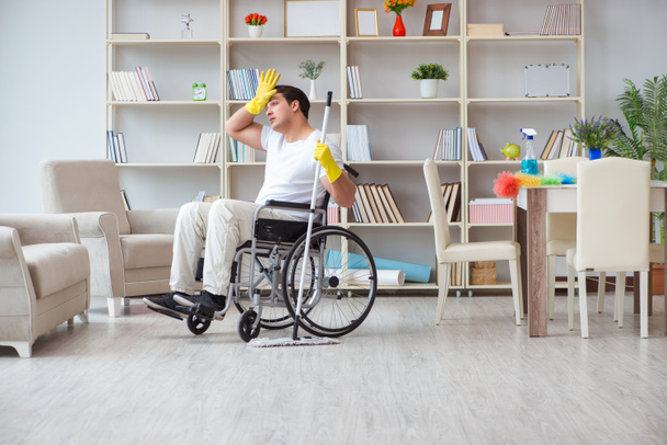 Disabled man cleaning floor at home - Fotó, kép
