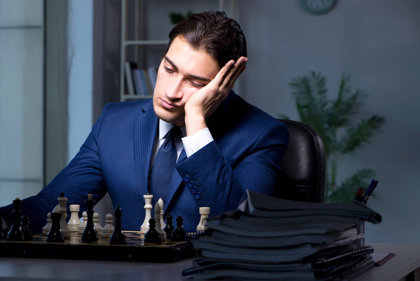 Businessman playing chess in strategy concept - Foto, Imagen