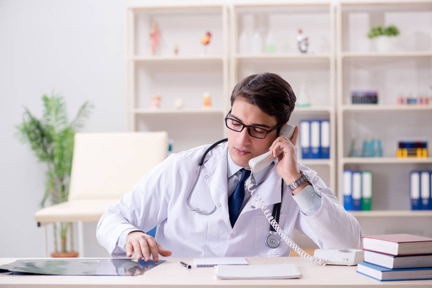 Young doctor sitting in the office - 写真・画像