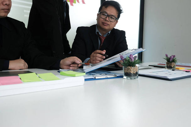 business adviser analyzing company financial report. professional investor discussing idea. businessman working on new startup project with co working team. - Photo, Image