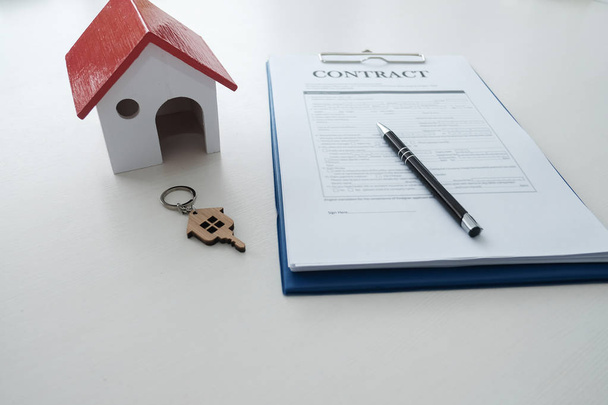 red house model, contract and key on table - Photo, Image