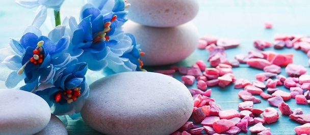 composition still life with blue flowers, massage stones, Spa concept, the substrate, a space on a wooden blue background - Foto, Imagen