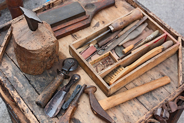 mesa de trabajo con herramientas antiguas del zapatero artesano
 - Foto, imagen