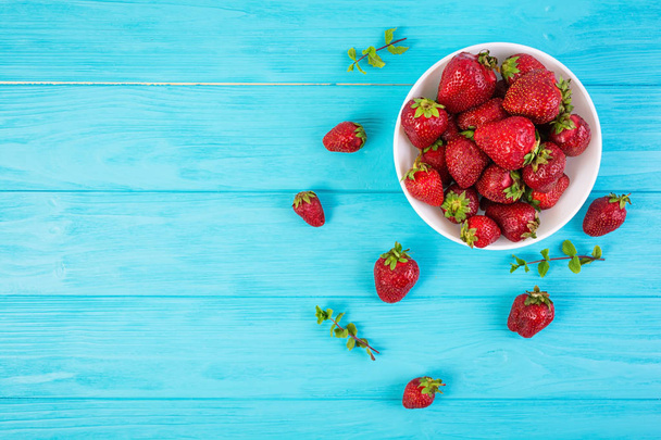 Fresh strawberry in bowl on wooden background - Photo, Image