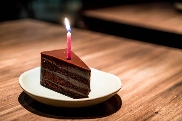 chocolate cake with birthday candle in restaurant cafe - Zdjęcie, obraz