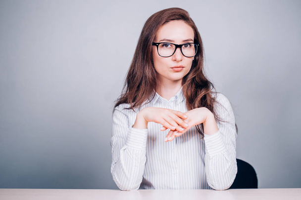 Modern business woman in glasses on white background. Brunette girl looks seriously at the camera - Фото, зображення