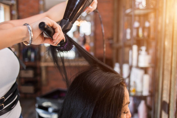 Female hairdresser making hairstyle to girl in beauty salon. Close up - Φωτογραφία, εικόνα