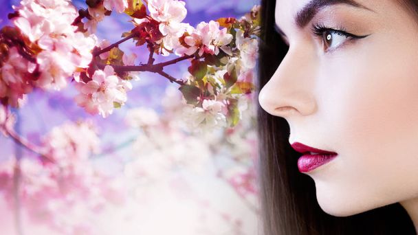 Portrait in profile, young beautiful brunette woman with bright lips. Lipstick purple color, free space, - Foto, Bild