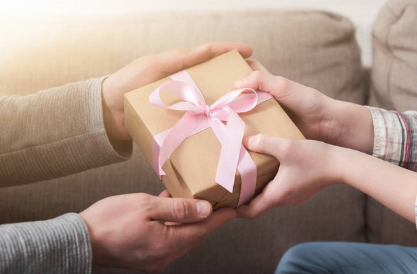 CLoseup of father hands gives gift to daughter - Foto, immagini