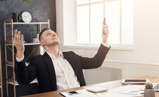 Satisfied businessman happy to finish work at office - Photo, Image
