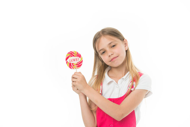 Girl with lollipop isolated on white. Little child hold candy with love lettering. Sweet beauty and look. Valentines day romance. Candyshop concept. Childhood and happiness. Sharing sweet love - Photo, Image