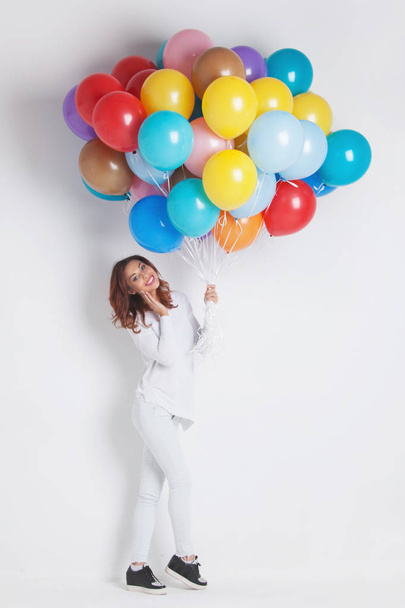 Happy woman with many colorful balloons on white - Valokuva, kuva