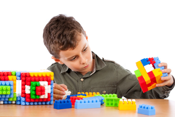 Little boy playing with plastic cubes - Photo, image