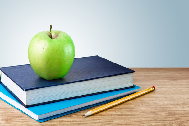 Book, notebook with apples and pencil on table - 写真・画像