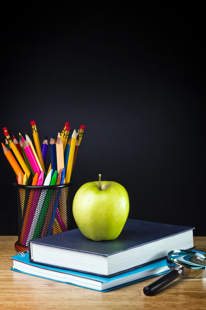 Teacher's desk with a color pencil, notebook and other equipment. - 写真・画像