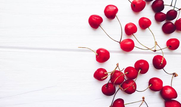 Many cherry on a white wooden background - Foto, Imagem