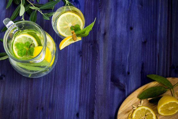 refreshing drink with lemon, mint and sage on a blue background - Фото, зображення