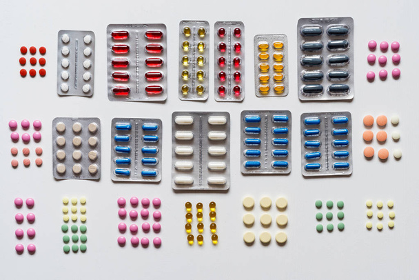 Set of blisters of colorful pills on a white background. Flat lay. - Foto, Imagem