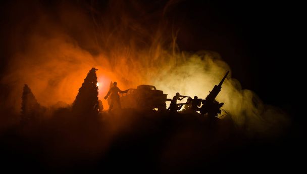 War Concept. Military silhouettes fighting scene on war fog sky background, World War Soldiers Silhouettes Below Cloudy Skyline At night. Attack scene. Armored vehicles. Selective focus. Decoration - 写真・画像