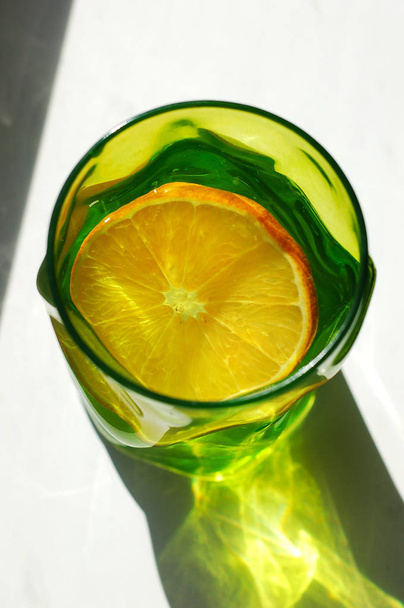cold refreshing lemonade in a colored glass - Fotoğraf, Görsel