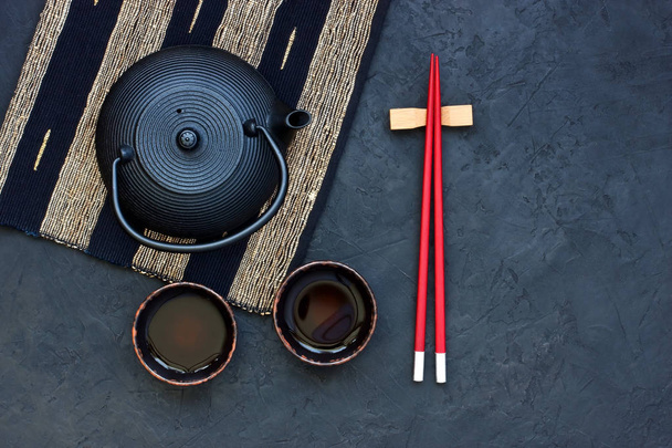 Asian food concept (green tea, cups and chopsticks) with  copy space for text - 写真・画像