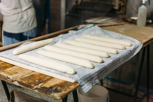 Raw dough bread before baking in a wood oven. Traditional Bakery Concept. - Foto, immagini