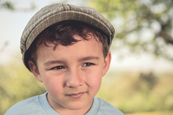 Child kid little boy portrait outdoor retro look looking to the side with cap nature - Foto, Imagem