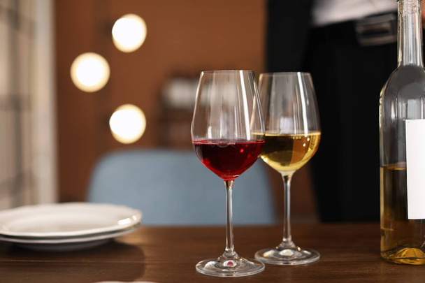 Glasses with tasty wine on table in restaurant - Fotografie, Obrázek