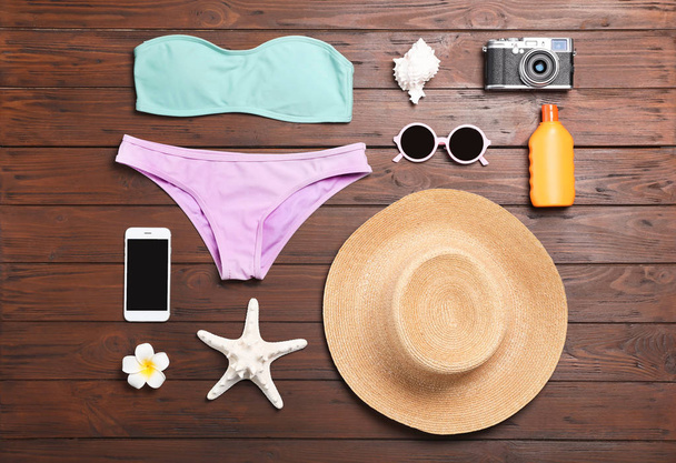 Flat lay composition with beach objects on wooden background - Fotó, kép