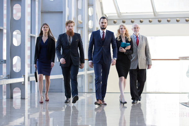 Business team walking in modern glass office building - Foto, Imagen