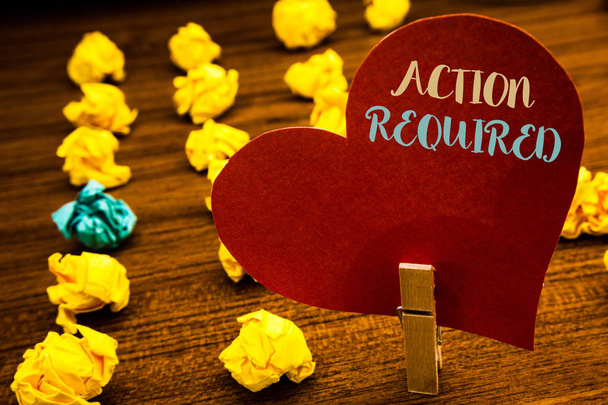 Text sign showing Action Required. Conceptual photo Important Act Needed Immediate Quick Important Task Text red heart wood clip desk crumbled paper notes yellow blue love message - Photo, Image