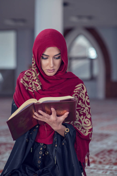 Muslim Woman Reading Koran Or Quran Wearing Traditional Dress At The Mosque - Photo, Image