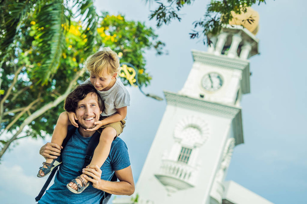 Father and son of tourists in the background of Queen Victoria Memorial clock tower, Penang. - Photo, image