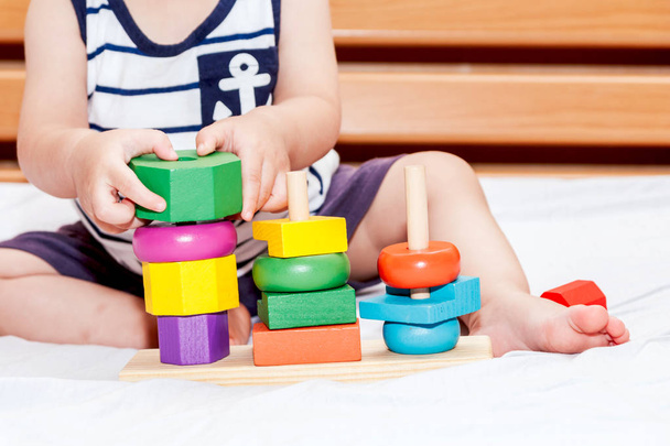 Baby boy playing with wooden blocks - Foto, imagen