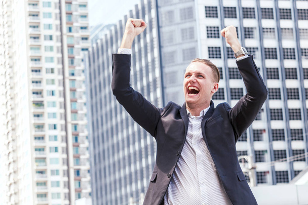 Successful businessman celebrating with arms up - Photo, Image