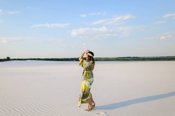 Fashionable woman wearing swimsuit and beach robe dancing on san - Valokuva, kuva